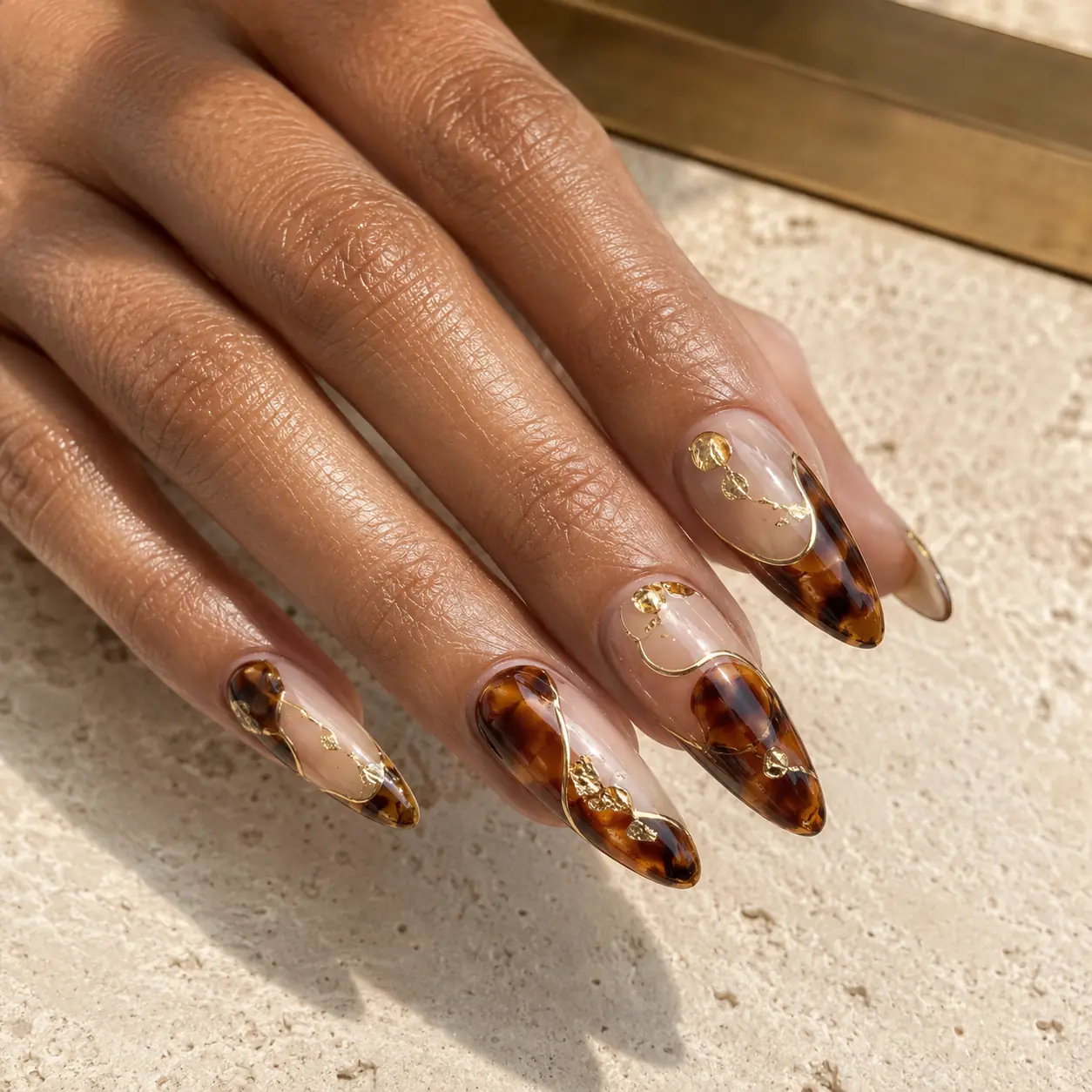 Sculpted tortoiseshell acrylic nails with gold chrome details in Phoenix